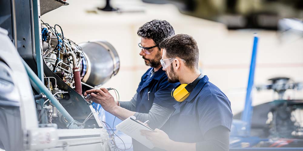 two technicians working on an aircraft