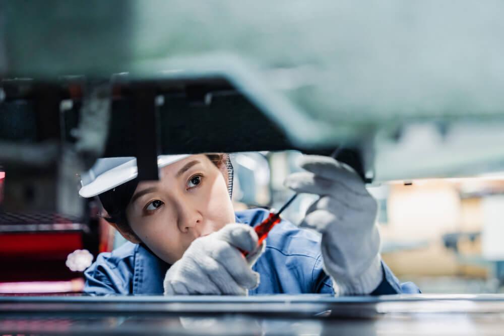 A factory worker assembling a car.